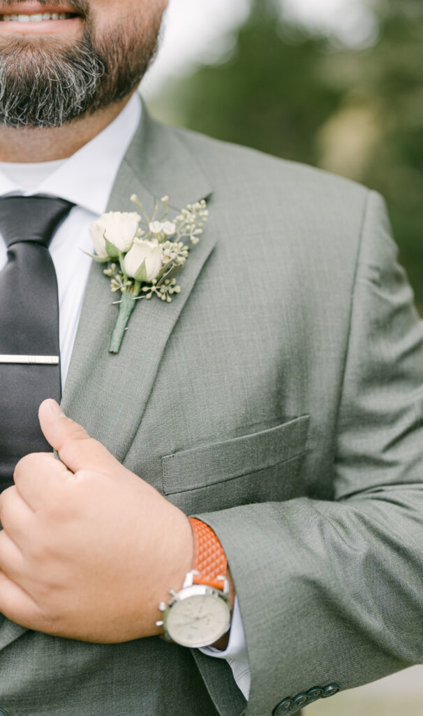 This Tennessee groom wears a simple boutonniere while his mother wore an intricate corsage. 