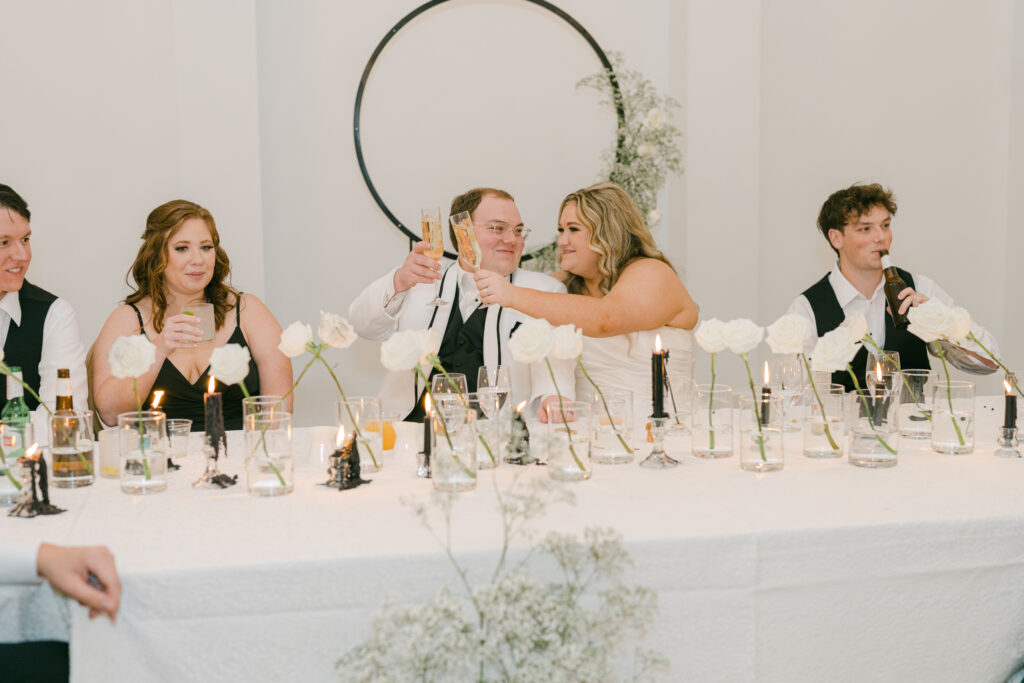Raleigh wedding couple taking in toasts from loved ones at their reception. 